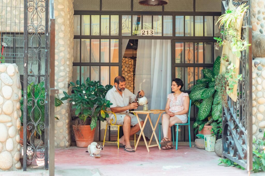 a man and woman sitting at a table outside