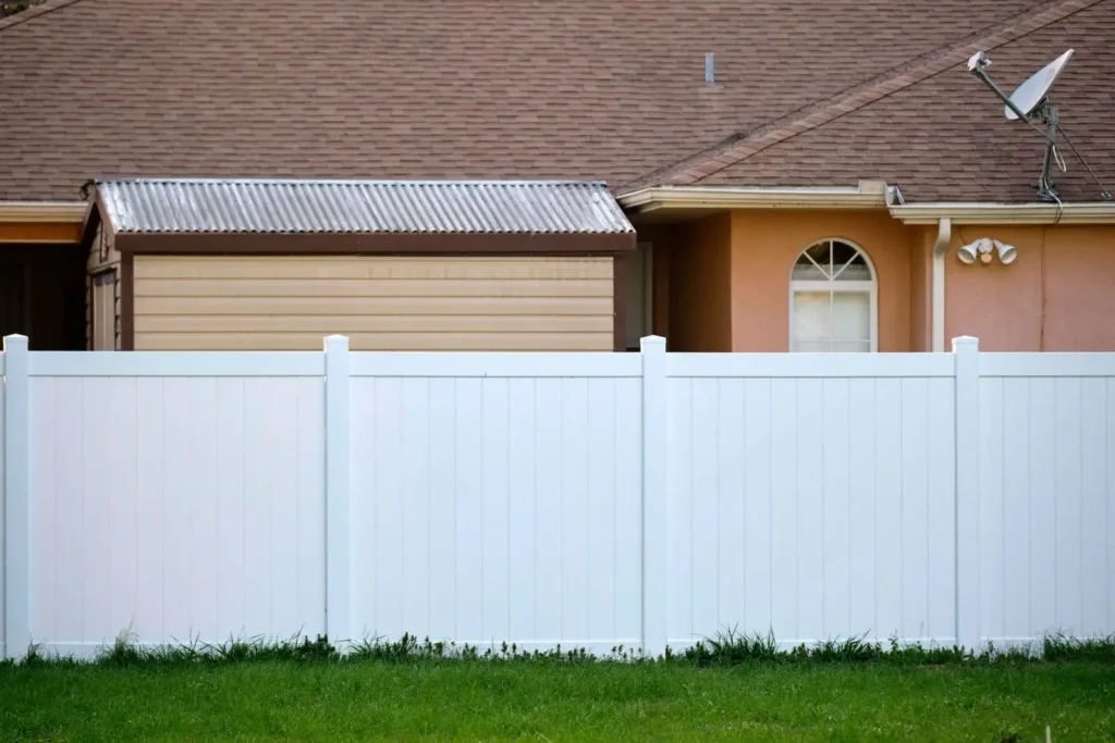Vinyl privacy fence in front of a residential home, showcasing durability and low maintenance suitable for Florida's climate.